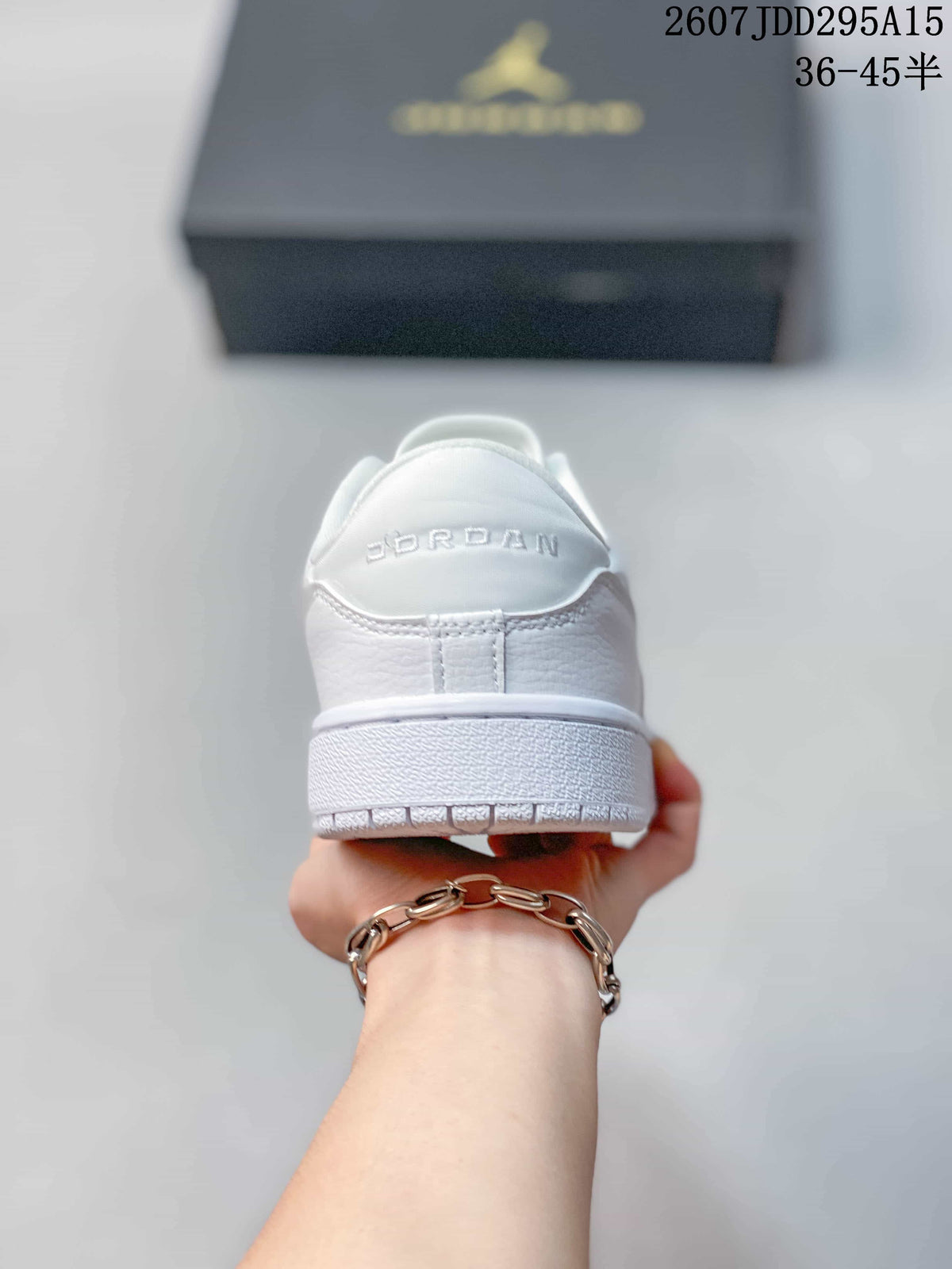 Rear view of the white sneaker showing Jordan lettering on the heel and the layered outsole.