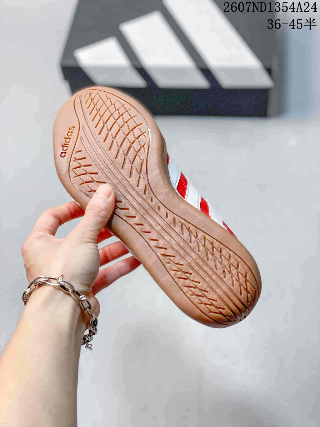 Close view of the gum-colored outsole showing its textured tread pattern and adidas branding.