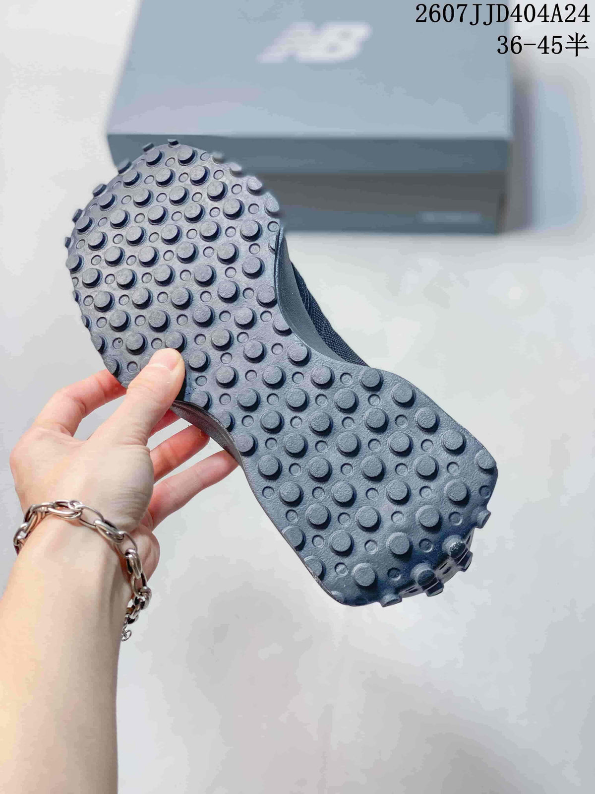 Close view of the black sneaker outsole showing raised circular lugs