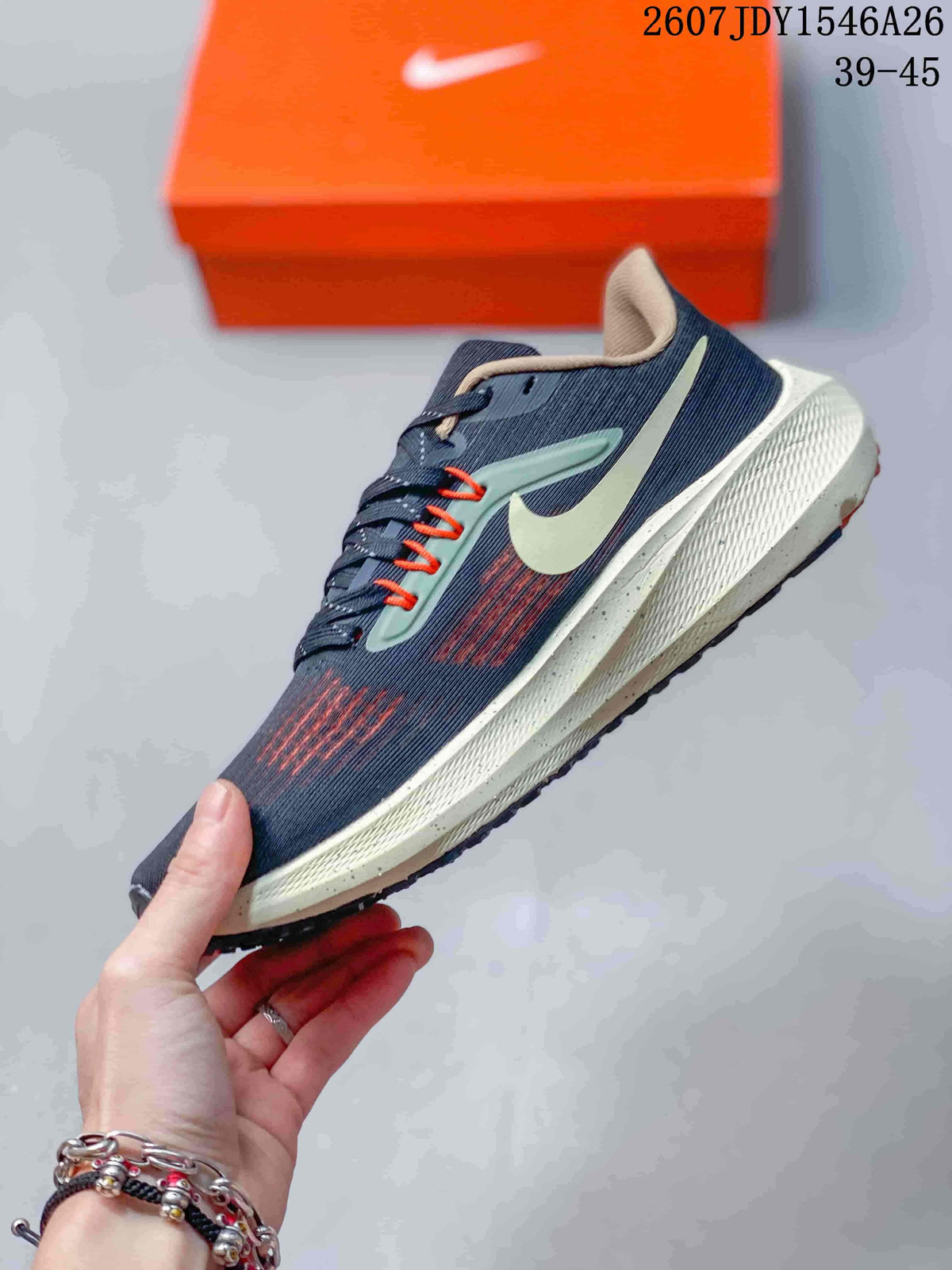 Side profile of the navy sneaker showing the Nike Swoosh, orange detailing, cream-colored midsole, and low-top construction.