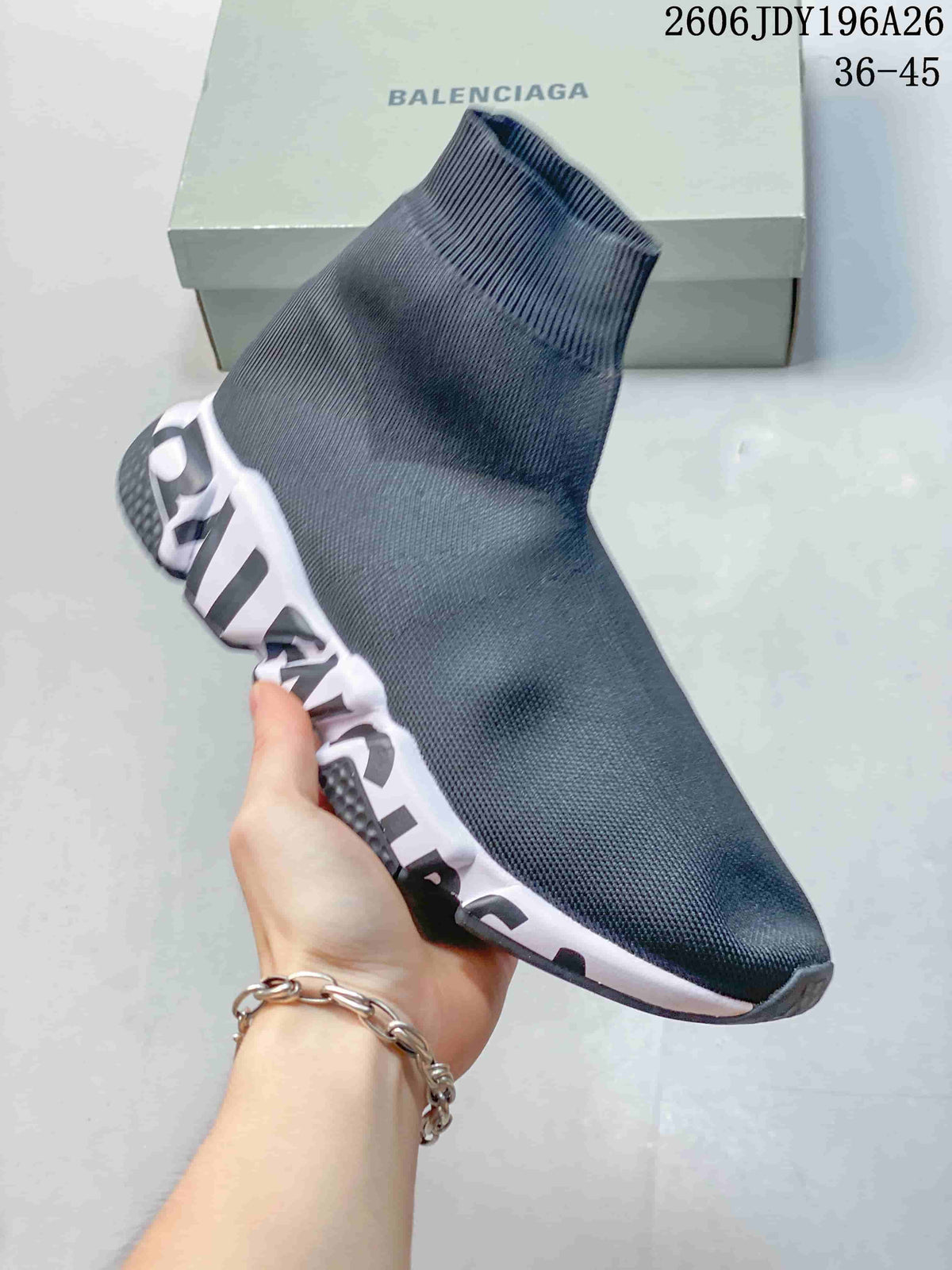 Close-up of a plain dark gray sock-style sneaker with a bold-lettered sole.