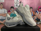Beige sneakers displayed at an angle, showing the side panels and sculpted soles