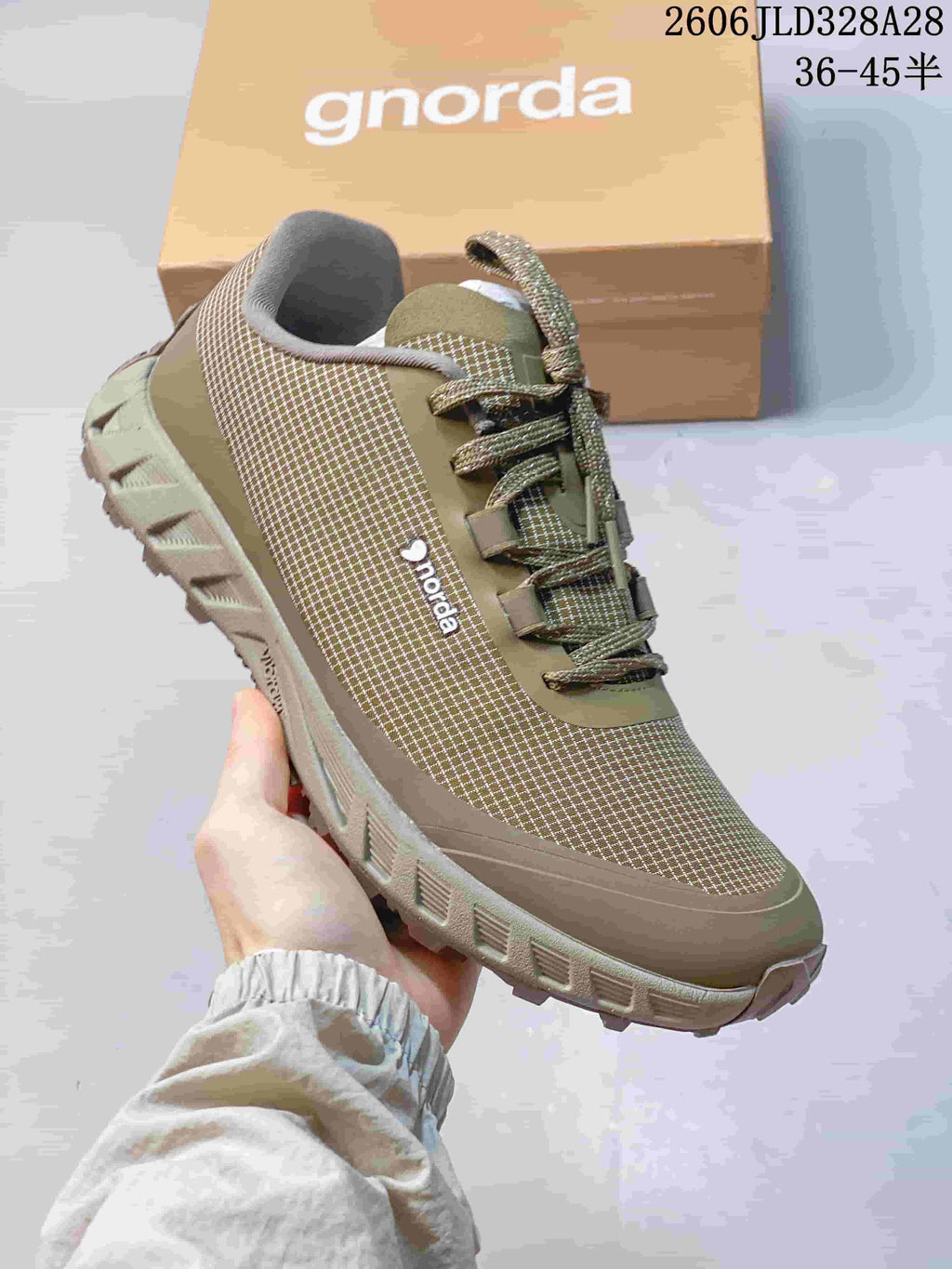 Angled side view of an olive NORDA hiking shoe with a patterned upper and rugged-looking outsole.