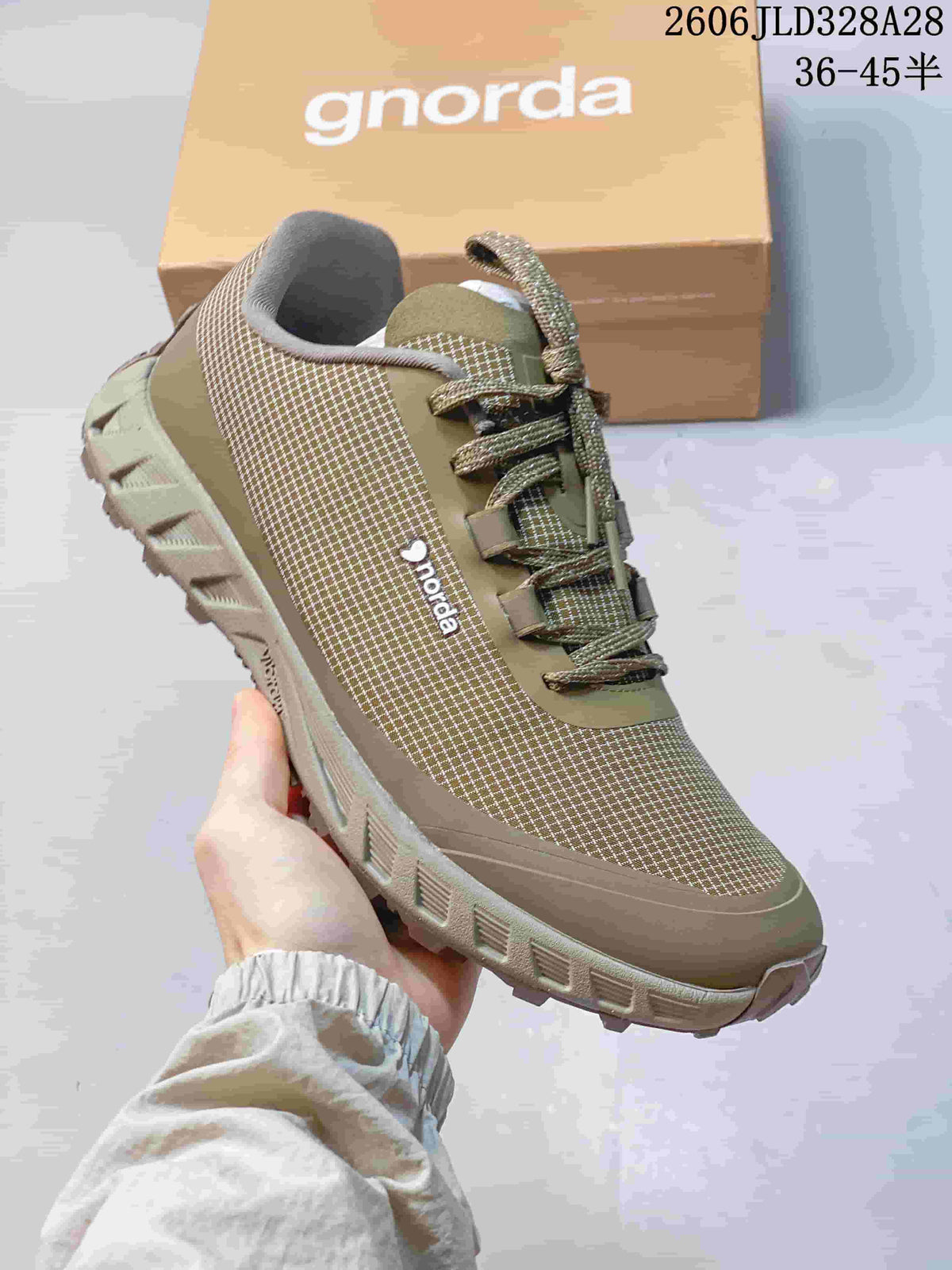 Angled side view of an olive NORDA hiking shoe with a patterned upper and rugged-looking outsole.