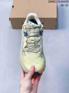 Top view showing the cream mesh upper and quick-lace system of the Salomon trail shoe.