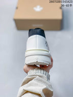 Rear view showing the white heel counter, navy collar, and raised sole