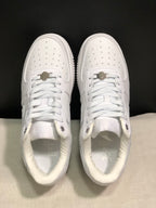 Top view of the white pair showing perforated toe boxes, white laces, and metal lace details.