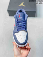 Top view showing the navy laces, red tongue logo, and perforated white toe panel.