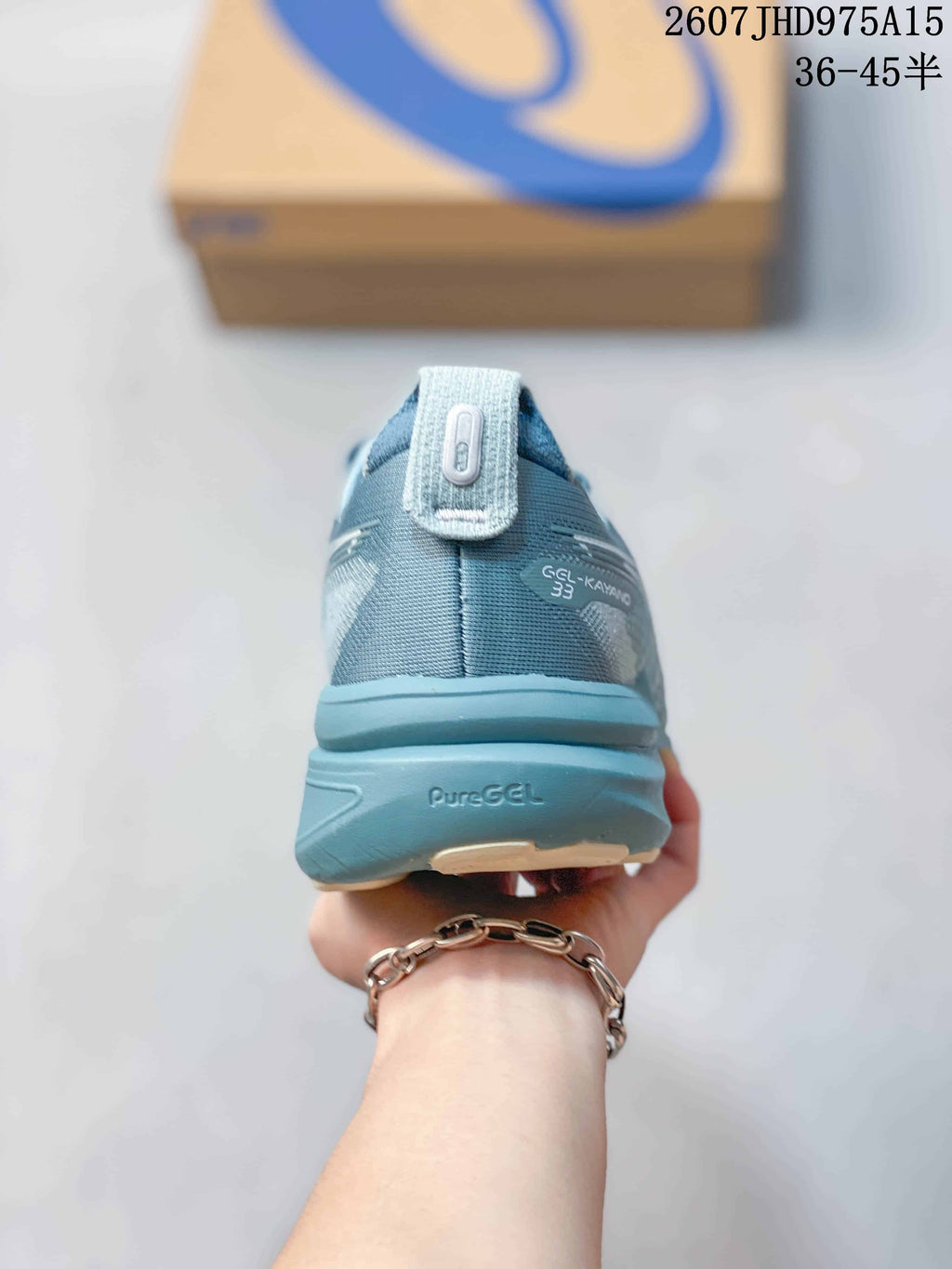 Rear view of the sneaker showing the heel tab, Gel-Kayano 33 marking, and PureGEL text.