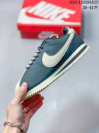 Side profile of the navy and cream sneaker showing the contrast Swoosh, stitched panels, and layered sole.