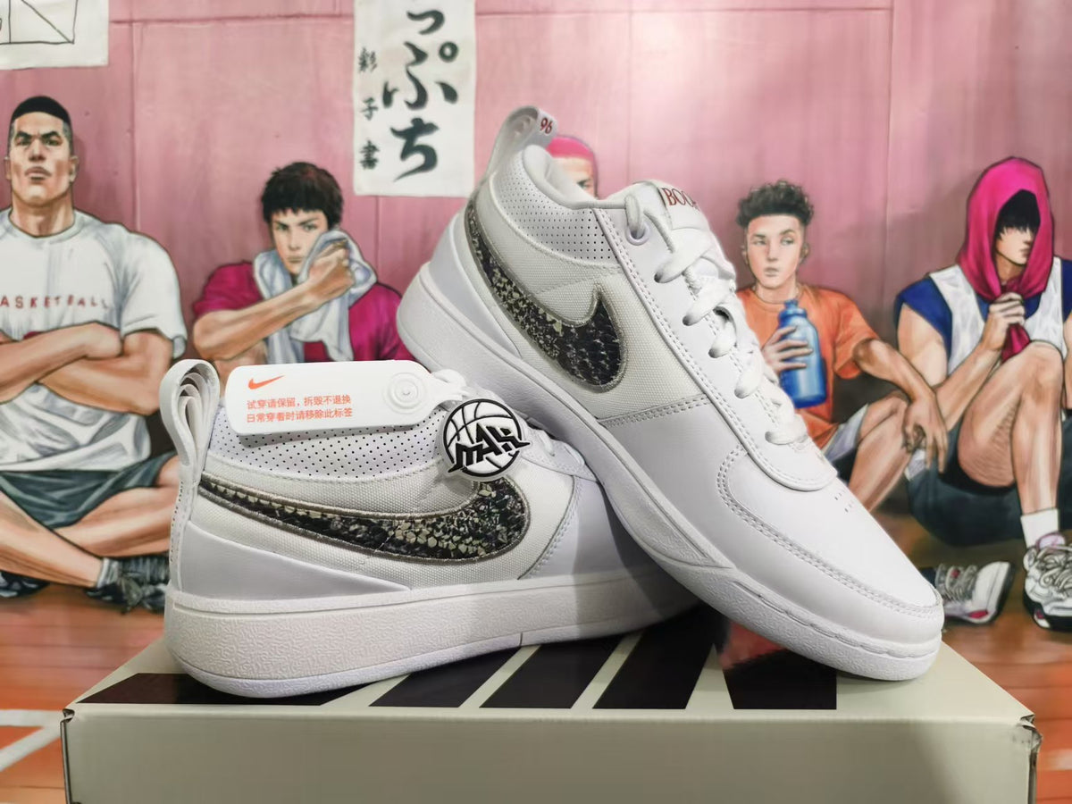 White Nike sneakers displayed at an angle, showing the patterned Swoosh and perforated upper