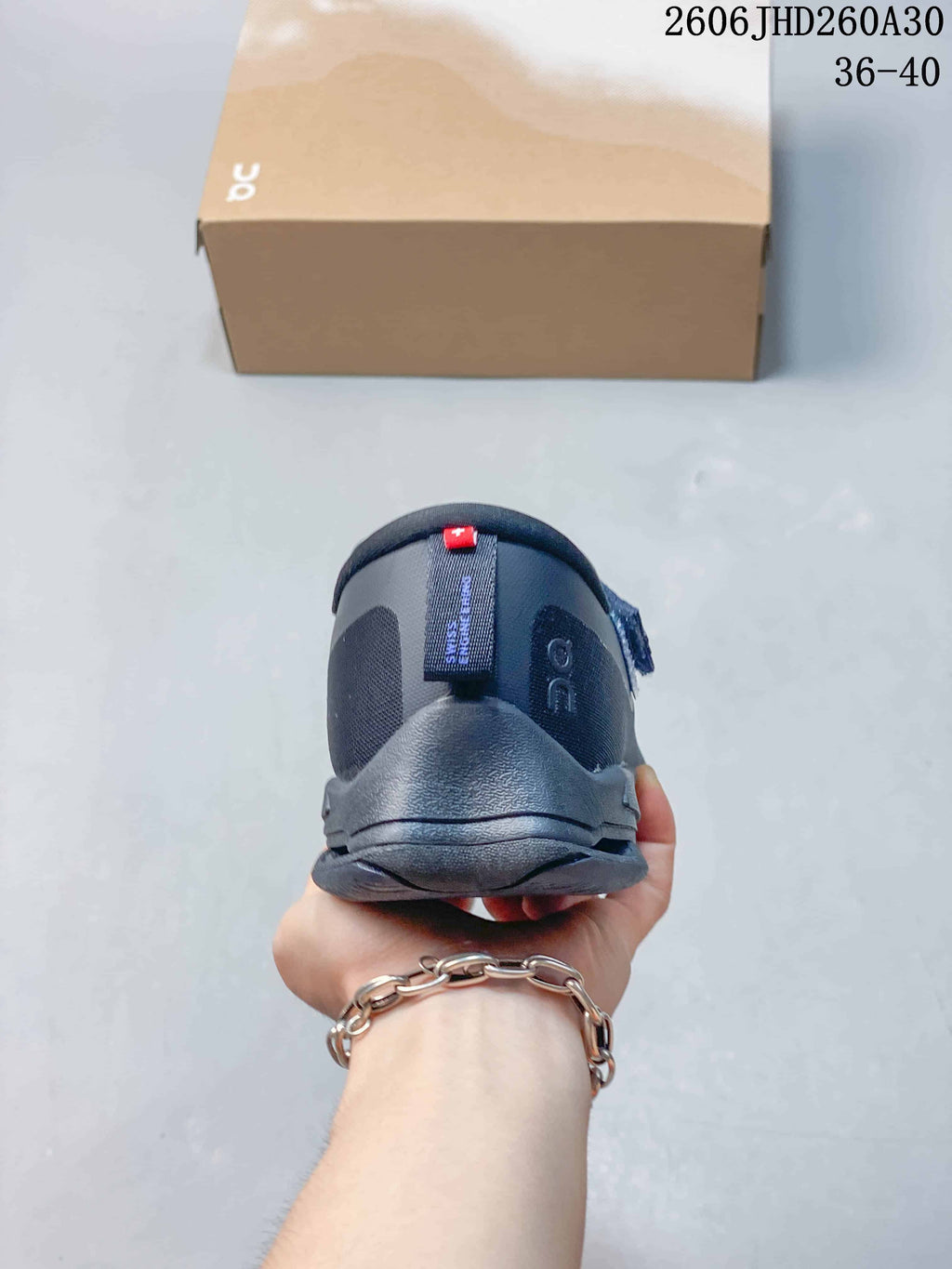 Rear view of a dark navy On Cloudnova Moon sneaker showing the heel.