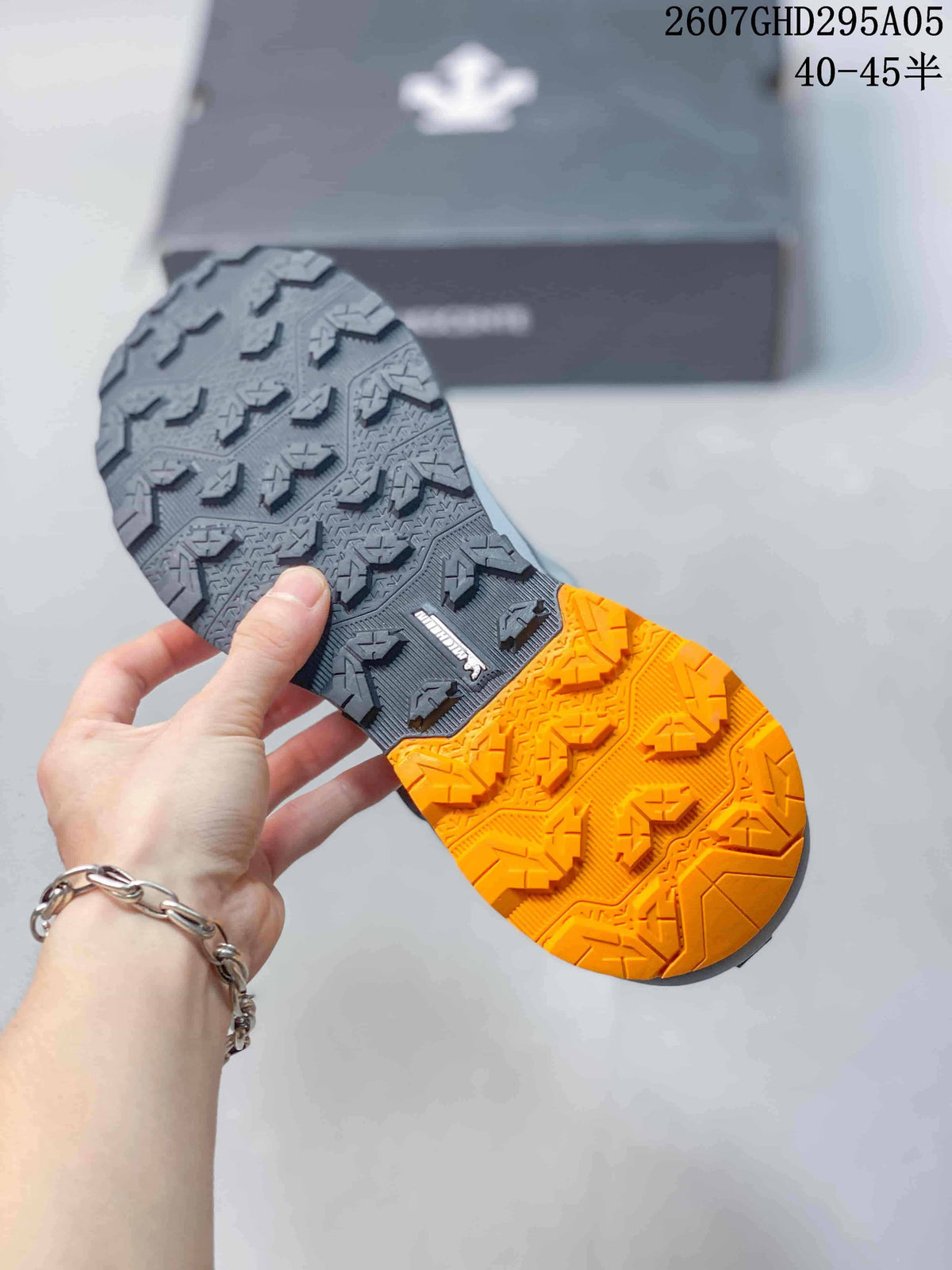 Close view of the sneaker outsole showing black and orange sections with a patterned tread; style code 2607GHD295A05 and size range 40–45 are overlaid.