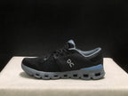 Side profile showing the low-top silhouette, textured upper, gray sole, and blue heel detail.