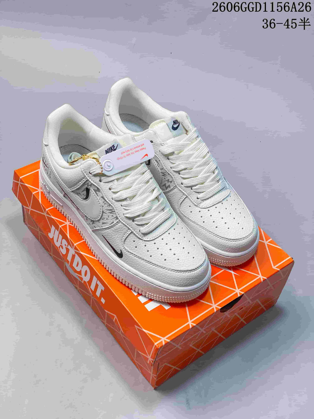 Pair of cream-white low-top Air Force 1 sneakers with patterned side panels and round metallic lace charms