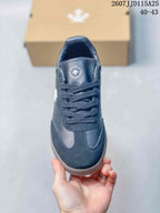 Top view of the sneaker showing the tongue logo, laces and layered toe-panel design.