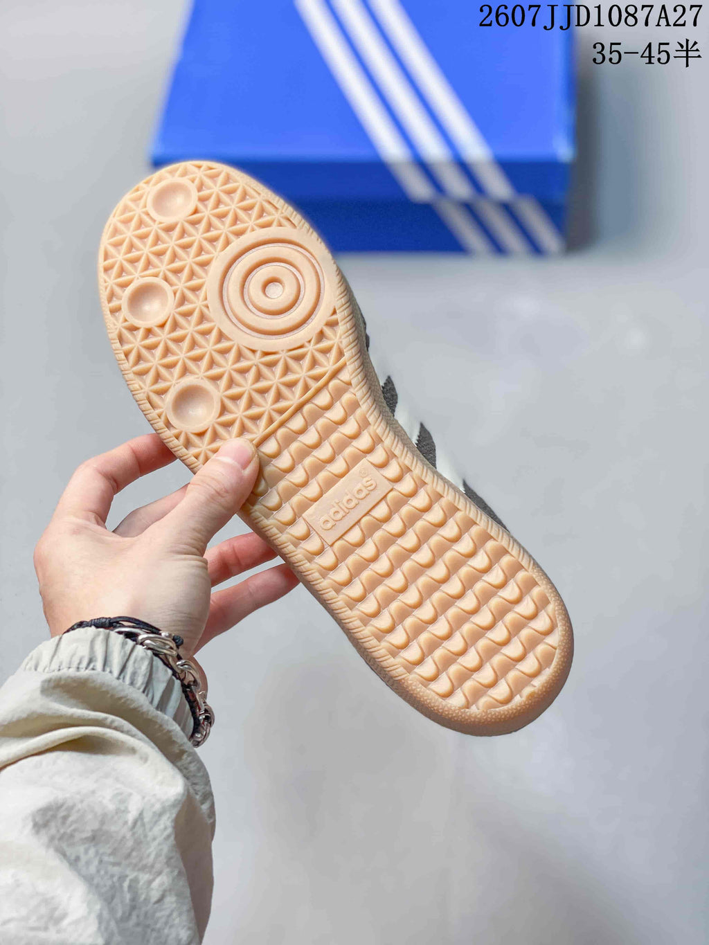 Close-up of the gum-colored outsole showing its textured tread pattern and adidas branding.