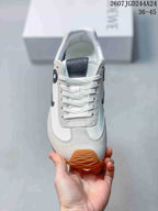 Top view of the sneaker showing white laces, branded tongue and rounded toe.