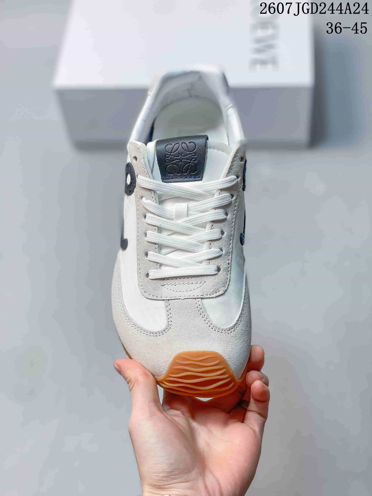 Top view of the sneaker showing white laces, branded tongue and rounded toe.