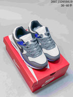 Pair of gray, white, and blue Nike sneakers displayed on a red shoe box, with the size range 36–46 shown in the image.