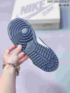 Underside view of the sneaker showing the patterned navy rubber outsole.