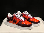 Pair of burgundy and orange Bape Sta low-top sneakers shown from a front three-quarter angle.