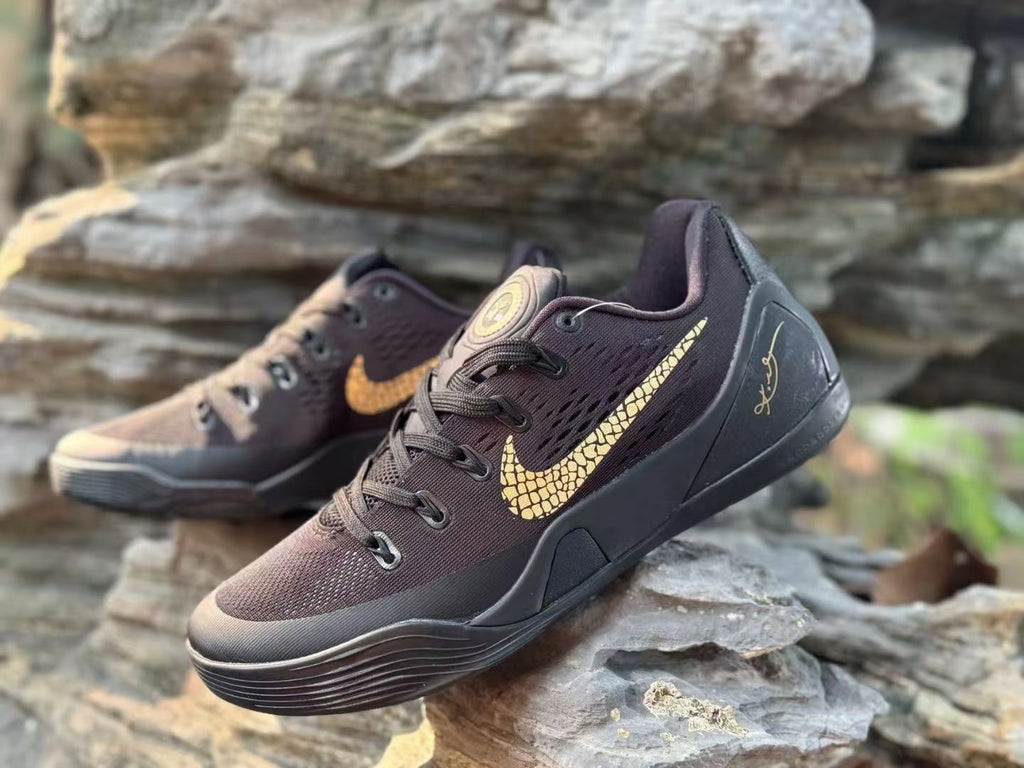 Close angled view of the black Kobe 9 upper, laces and gold-toned graphics.