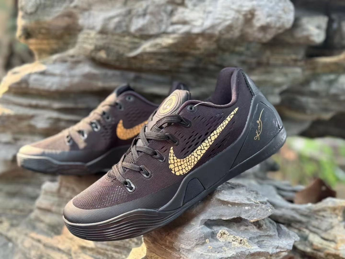 Close angled view of the black Kobe 9 upper, laces and gold-toned graphics.