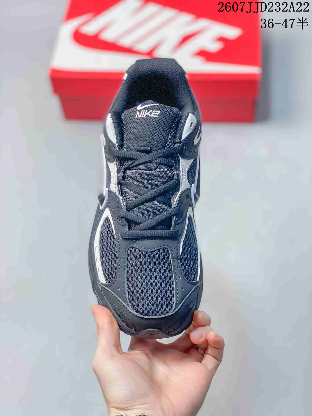 Top view of a black and white Nike V5 RNR sneaker showing the mesh toe box, laces, padded tongue, and collar.