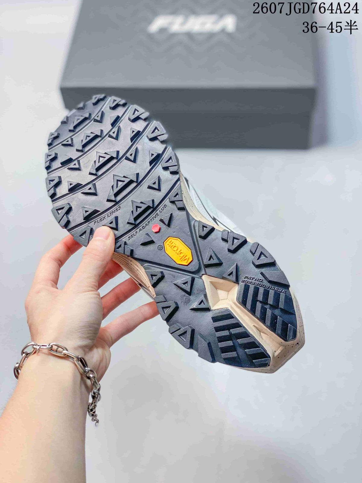 Underside view of the shoe showing the deep triangular lug pattern and visible Vibram outsole branding.