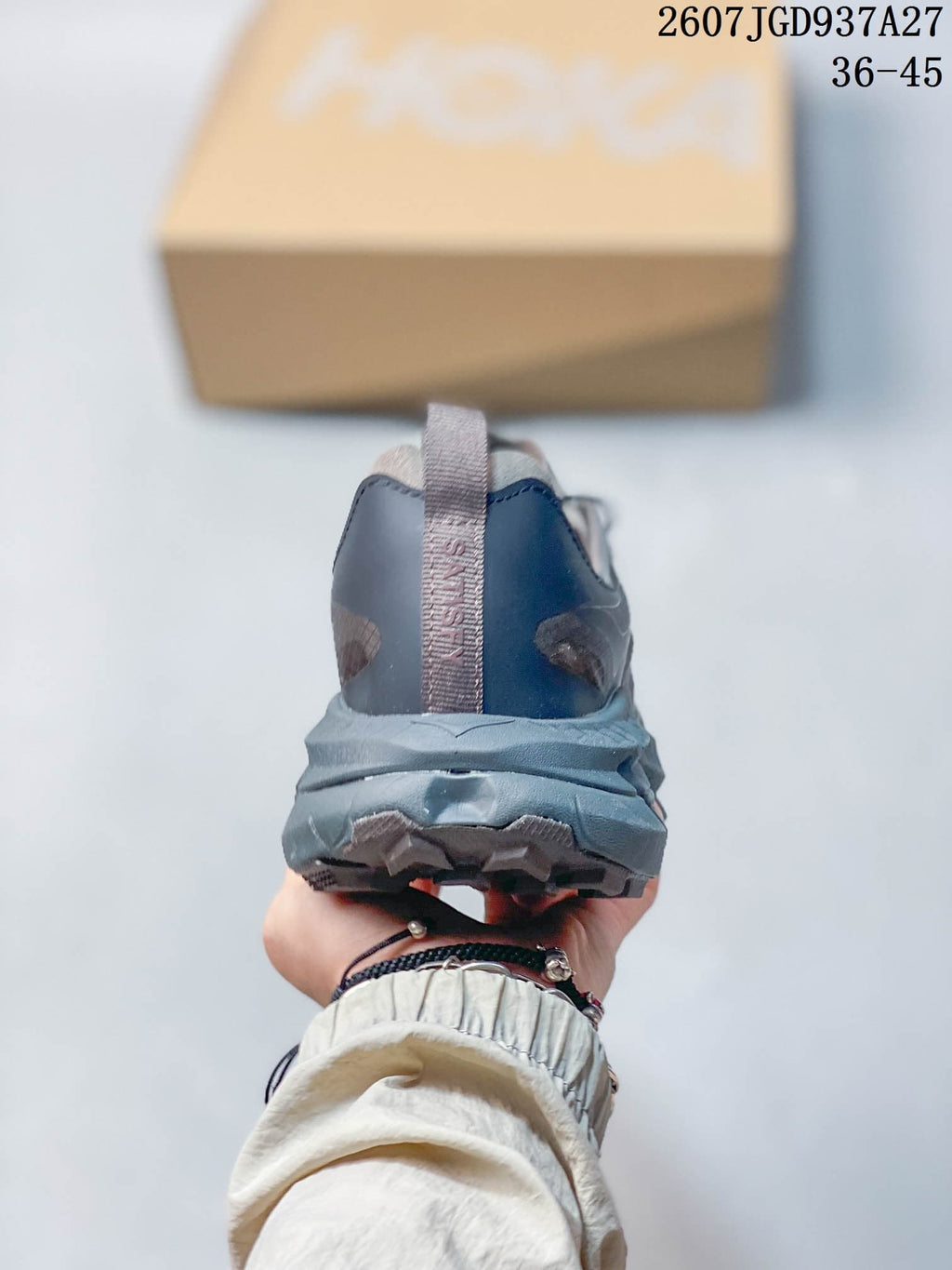 Rear view of the black and gray sneaker showing the padded heel, pull tab, and layered sole.