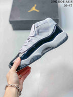 Side view of the high-top sneaker showing the glossy dark navy side panel, grey upper and layered midsole.