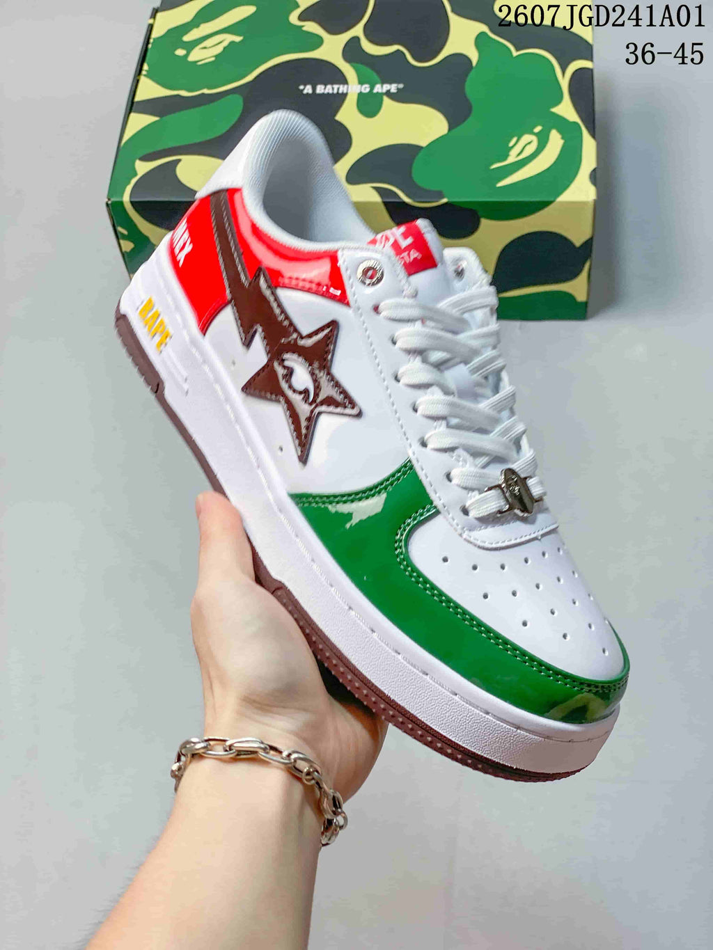 Angled view of a white, green, and red low-top sneaker with a star-shaped side detail