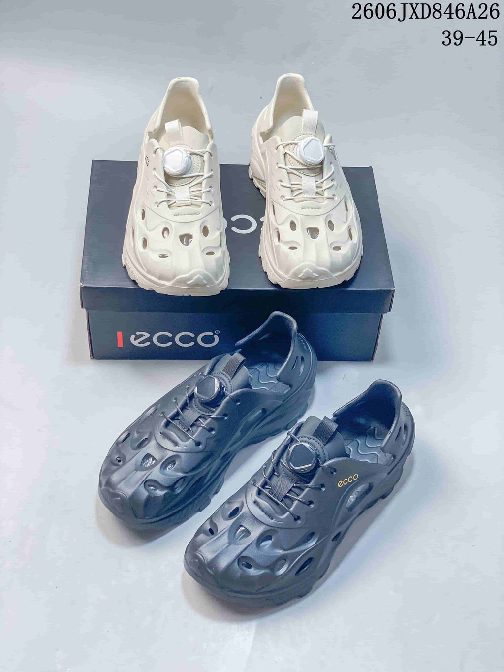 White and gray colorways of perforated closed-toe shoes shown together.