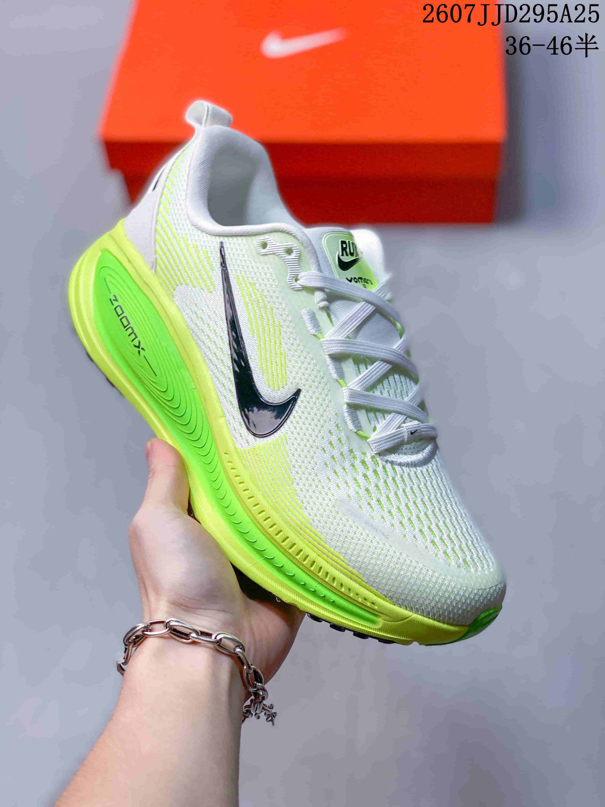 Angled side view showing the white and neon green Nike Vomero 18 upper, black Swoosh and raised green midsole.