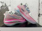 Pair of pink and grey Nike GT Cut 3 basketball shoes shown at an angle