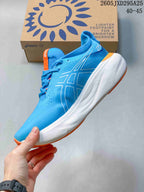 Side profile of the blue ASICS running shoe with white midsole and orange trim