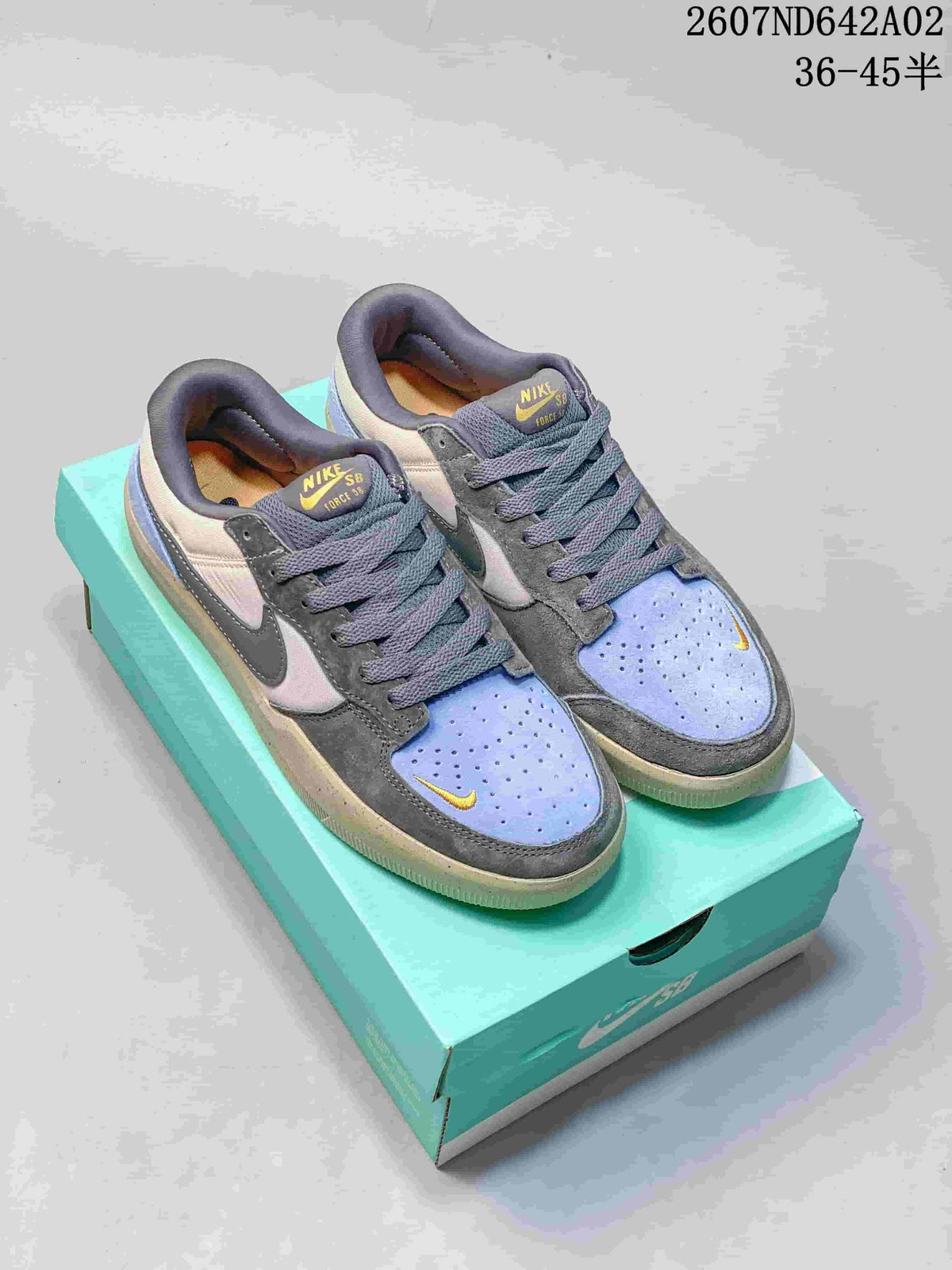 Pair of Nike SB Force 58 low-top shoes in gray, pale neutral, light blue, and yellow on a turquoise box