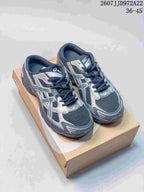 Pair of dark navy and silver ASICS Gel-1130 sneakers displayed on a shoebox.