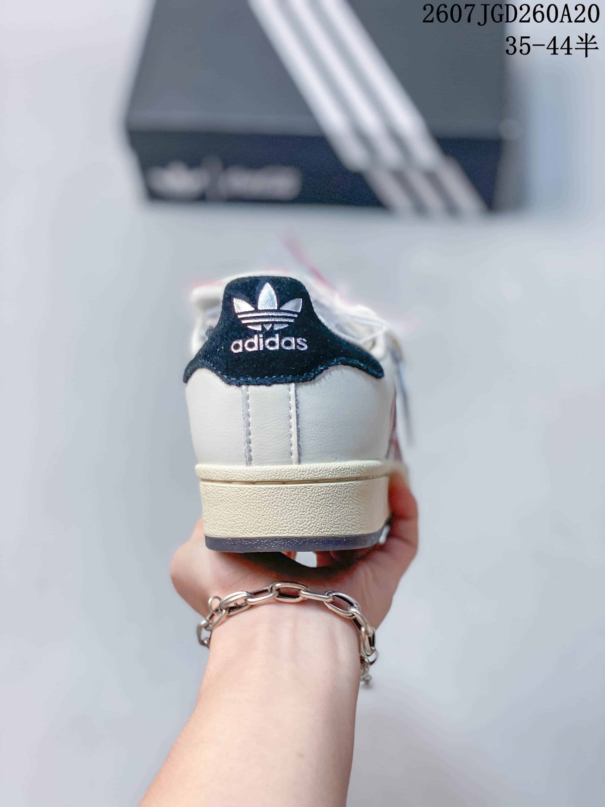 Rear view showing the Adidas trefoil logo on the dark heel tab and layered light midsole.
