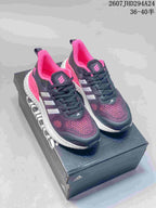 Pair of black, pink and white adidas Switch FWD sneakers displayed on an adidas shoebox.