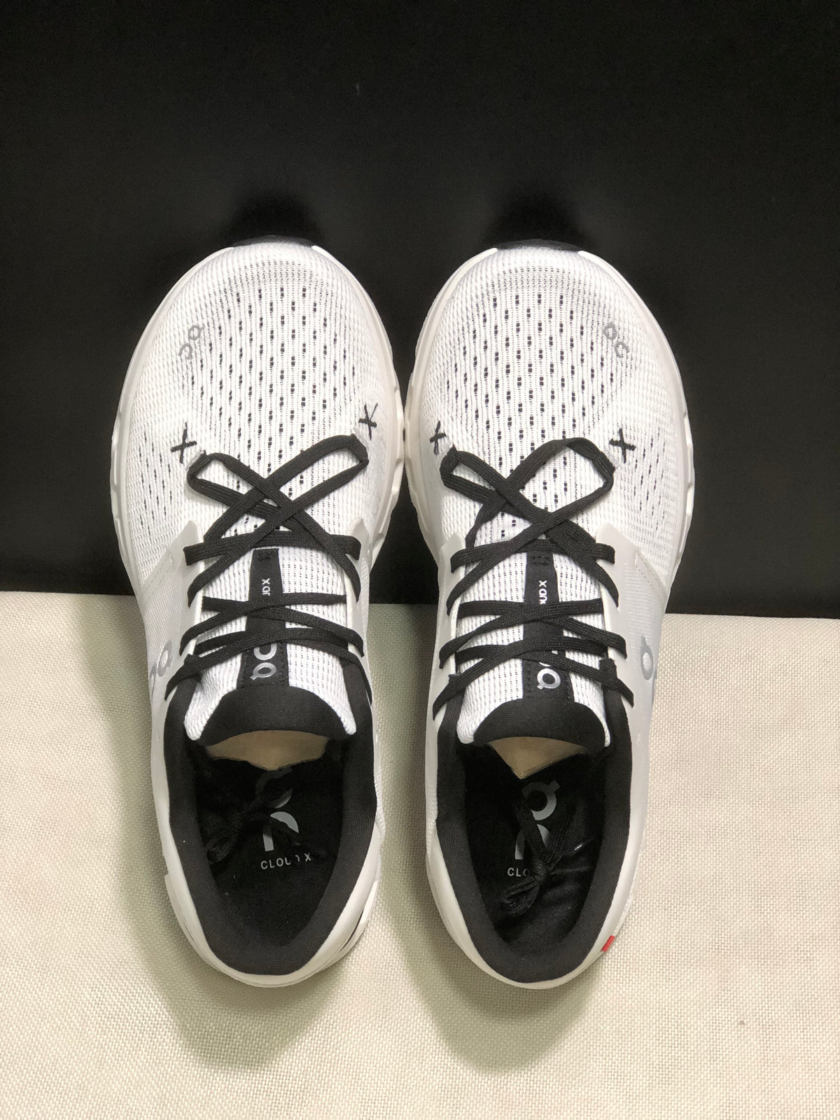 Top-down view showing the perforated forefoot, black laces, padded collars, and tongue branding.
