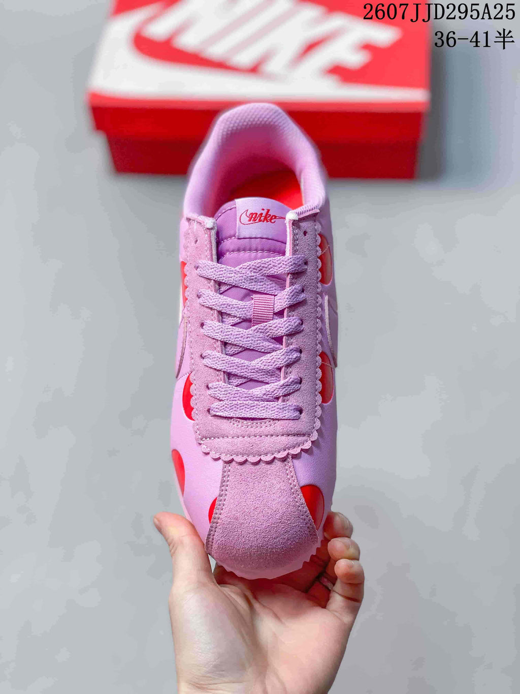 Top view showing the lace-up vamp, padded tongue, and scalloped pink trim.