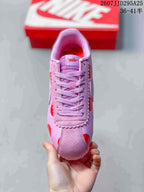 Top view showing the lace-up vamp, padded tongue, and scalloped pink trim.