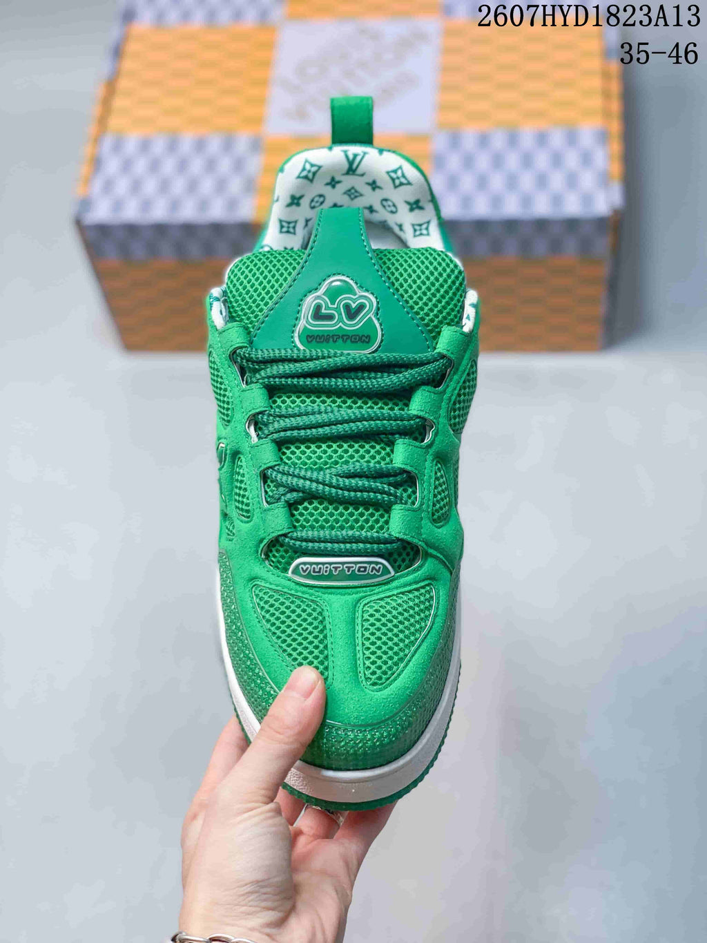 Top view of the green sneaker showing green laces, mesh tongue, patterned collar lining and branded details.
