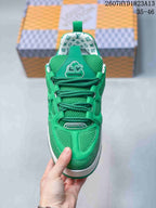 Top view of the green sneaker showing green laces, mesh tongue, patterned collar lining and branded details.
