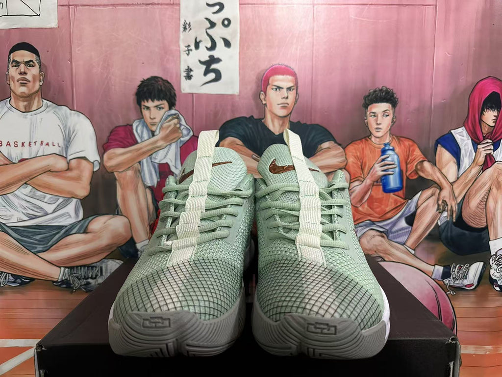 Front view of jade green Nike basketball sneakers showing textured toe panels, laces, tongue details, and white midsoles.
