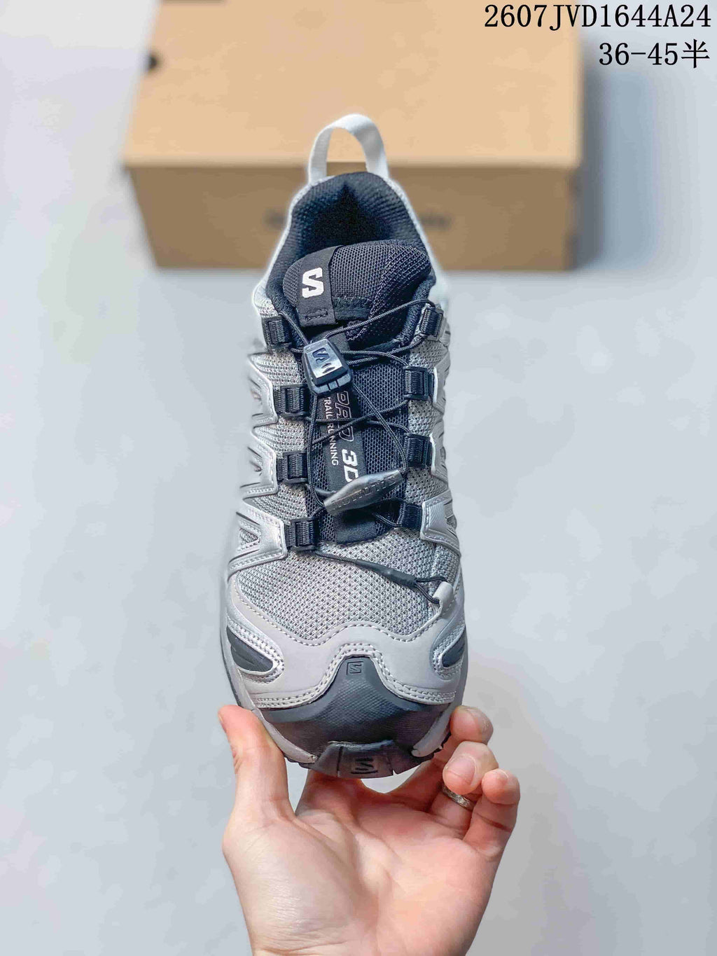 Front view of the Salomon sneaker showing the mesh toe box, padded tongue, quick-lace system, and dark toe bumper.