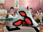 Outsole and side view showing red tread sections and black panels