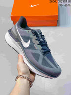 Side view of a dark gray Nike running shoe with a white logo and ReactX-marked midsole.